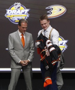 Jun 24, 2016; Buffalo, NY, USA; Max Jones puts on a team jersey after being selected as the number twenty-four overall draft pick by the Anaheim Ducks in the first round of the 2016 NHL Draft at the First Niagra Center. Mandatory Credit: Timothy T. Ludwig-USA TODAY Sports