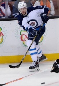 Jan 3, 2016; Anaheim, CA, USA; Winnipeg Jets right wing Drew Stafford (12) passes the puck in the second period of the game against the Anaheim Ducks at Honda Center. Ducks won 4-1. Mandatory Credit: Jayne Kamin-Oncea-USA TODAY Sports